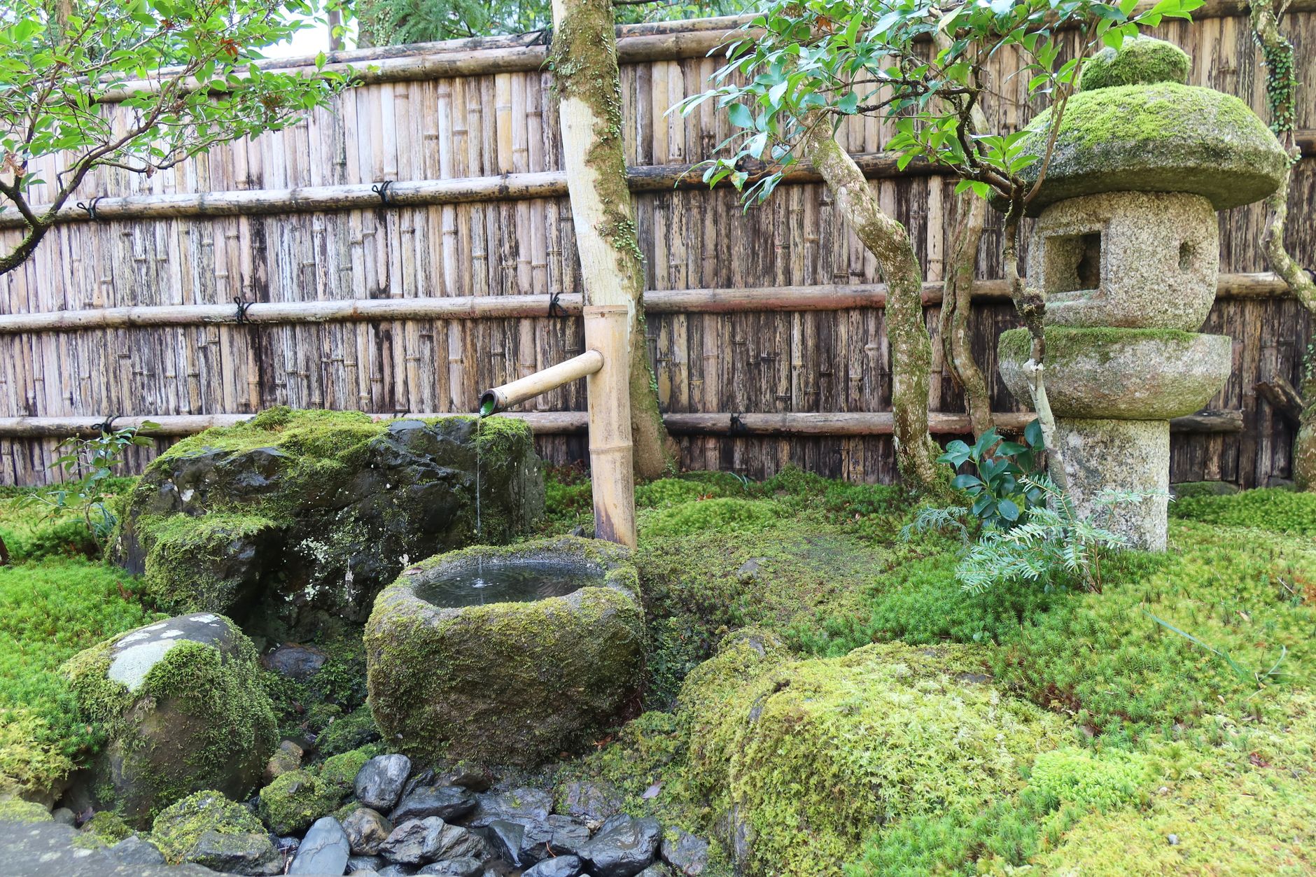 Wooden veranda of a traditional Kyoto temple overlooking raked gravel