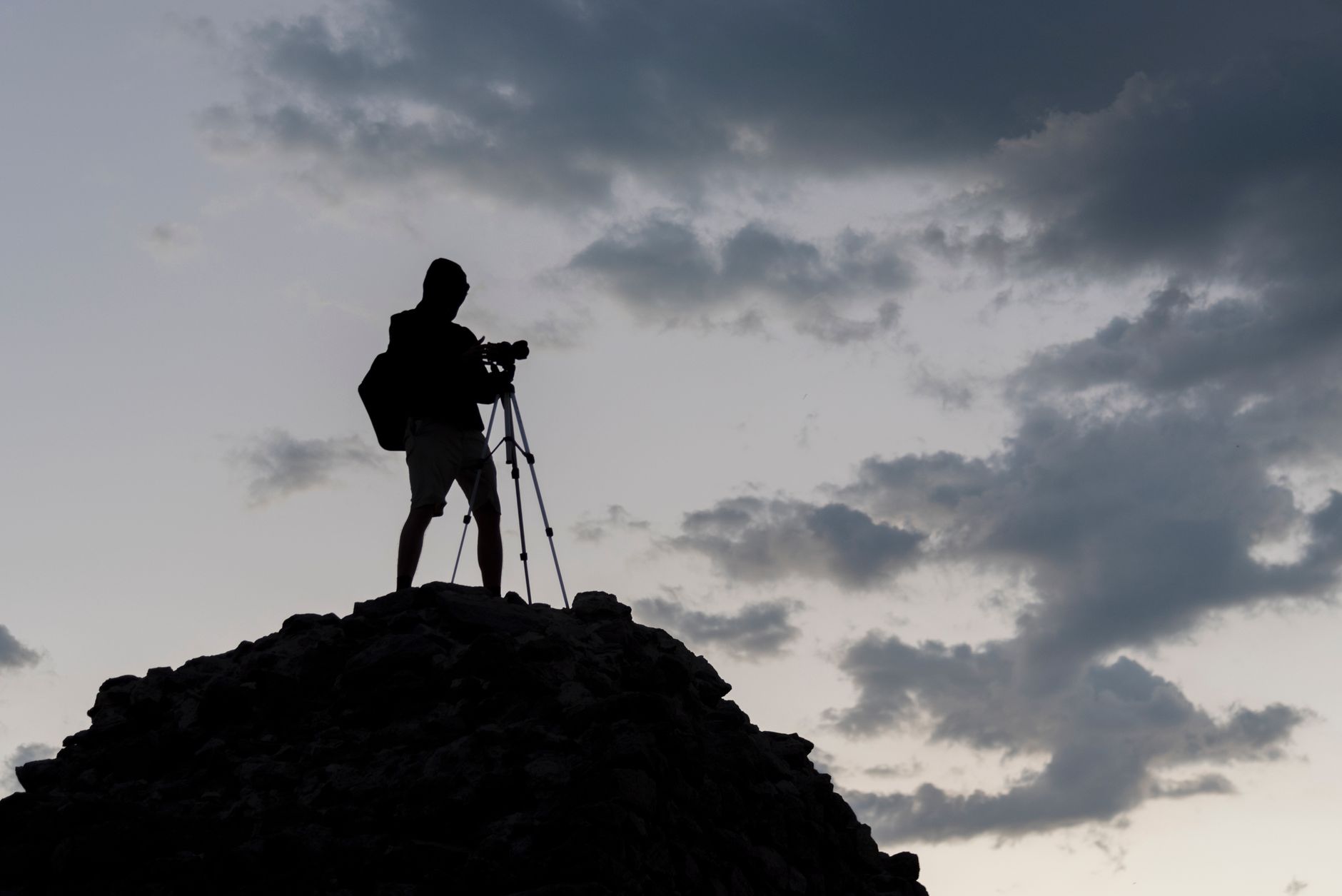 Photographer overlooking dramatic valley landscape
